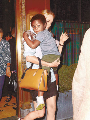 查理絲在紐約時抱着養子積遜上街。（東方IC圖片）