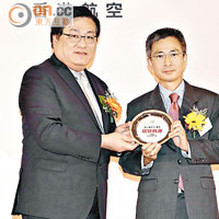 東方報業集團主席助理鄧國雄（左）向頒獎嘉賓之一的香港市務學會副主席鮑健輝（右）致送紀念狀。