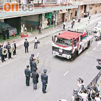 靈車駛至麗昌工廠大廈，同袍獻上花圈致祭。	（譚威權攝）