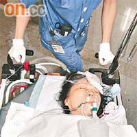 墮樓婦人頭部受傷，被推往病房留醫。（陳桂建攝）