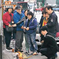 死者妻子與女兒及親友昨午在場路祭，難掩傷感。	（曾志恒攝）