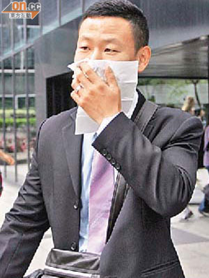 軍裝警員陳東海作供後用紙巾掩臉離開。	（林少權攝）
