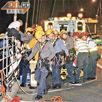 企圖跳橋男子由消防員協助爬回安全位置。