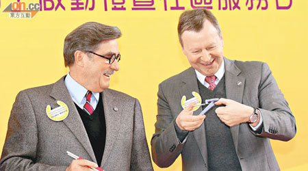 應家柏（右）示範使用裝有放大鏡功能嘅指甲鉗，而施文信（左）則手持彈弓筷子。