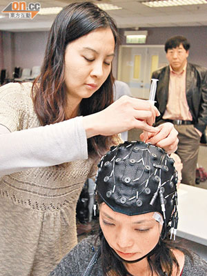 中大心理學系學生示範接受腦電波實驗，證明大腦在辨識漢字時會出現「N200」腦電波。（梁耀榮攝）