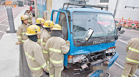 運雞車車頭嚴重損毀，消防員到場救出司機。（周宏杰攝）