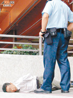 涉案男子被警員扣上手銬後，躺於地上亂叫。（朱偉坤攝）