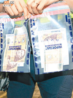 警方展示行動中檢獲的作廢秘魯紙幣。（馮戈攝）