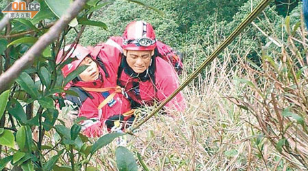 民安隊員游繩而下救起被困崖邊女子。
