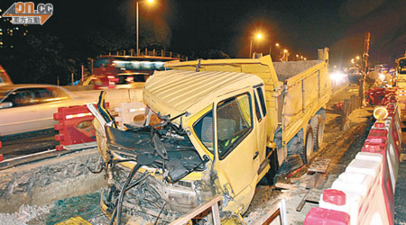 泥頭車剷落工地，車頭撞毀，司機送院證實不治。（文健雄攝）