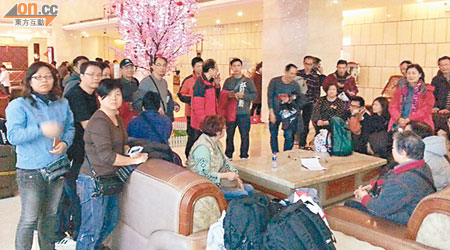 團友們遊畢張家界後返到酒店獲知沒有高鐵票回深圳，一起商討解決辦法。（讀者提供）