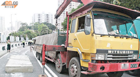 石屎板從貨車翻落路面，警方封路調查。（張曉楠攝）