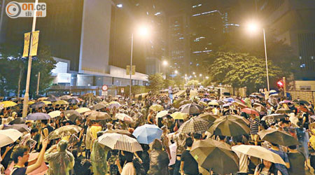 昨凌晨下雨，群眾撐傘包圍特首辦。
