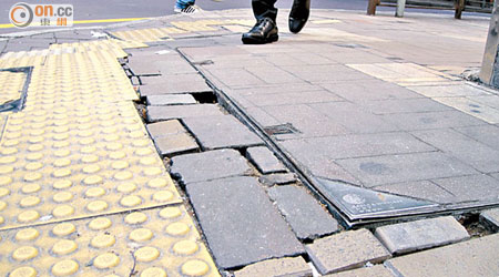 鋪設路磚的行人路出現凹凸不平情況，途人或有絆腳受傷危機。