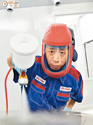 工人噴油時需穿上全身保護裝備。