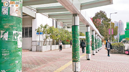 富昌邨外行人上蓋的支撐柱滿布膠紙，居民促加強清理。