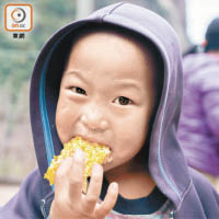 在涼山鄉村，一名小孩正品嘗新鮮蜂蜜。
