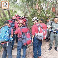 民安隊隊員配備裝備登山。