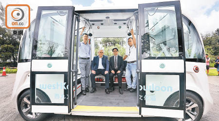 香港首部無人駕駛電動車載客量為十一人，不設企位，左二為栢志高。