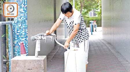 元州邨<br>元州邨住戶仍會帶水桶到樓下取水回家使用。