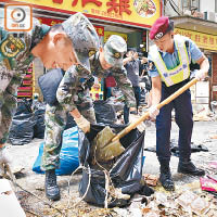 解放軍部隊與警員協力清理垃圾。