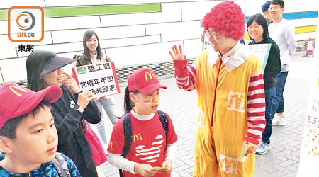 工會代表打扮成「麥當勞叔叔」到活動會場外贈興。（飲食及酒店業職工總會提供）