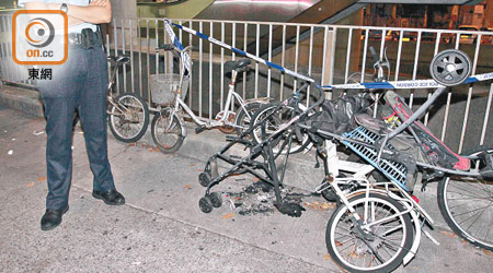停泊於路邊的單車及嬰兒車遭燒毀。（楊日權攝）