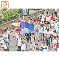 遊行隊伍中，有人手持香港旗。（黃偉邦攝）