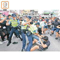 警方揮動警棍制服示威者。