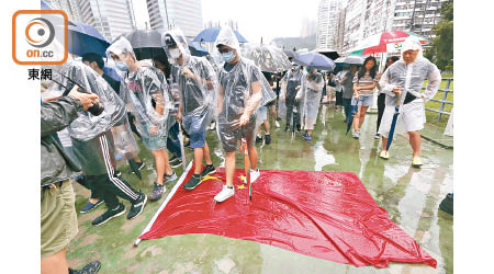 遊行人士將葵涌運動場的五星旗撕下鋪在地上。（何天成攝）