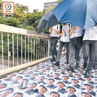 有人鋪貼立法會議員何君堯的肖像在伊館附近天橋讓行人踩過。