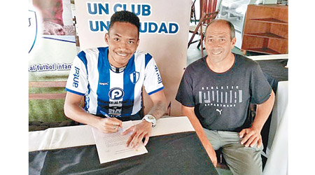 霍斌仁（左）簽約烏拉圭球隊，是香港足球史上首次。